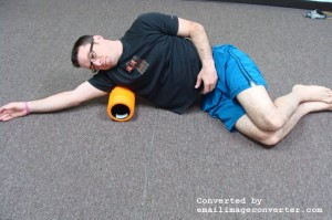 Placing the foam roller at the armpit. Lie on your side with your arm overhead. Slowly massage from the top of the arm to below the shoulder blade. Do not massage in the armpit area.