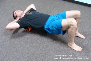 With foam roller on upper back, changing arm position will expose different muscles around the shoulder blade.