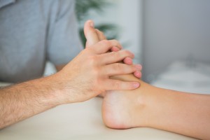 Hands on massage therapy on the plantar surface of the foot. 